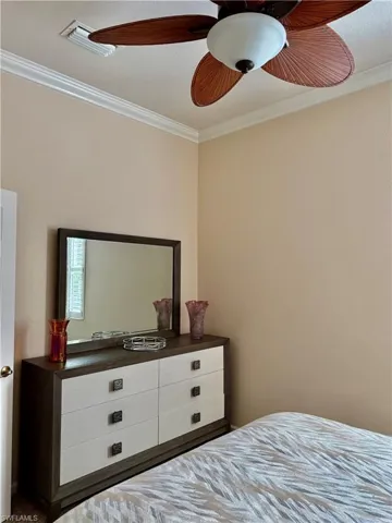 Bedroom featuring ornamental molding and ceiling fan