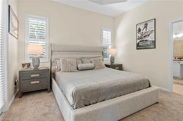 Bedroom featuring baseboards and light colored carpet