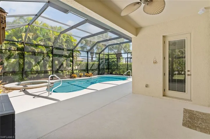 Outdoor pool featuring a patio, a lanai, an in-ground hot tub, a ceiling fan, and a sunroom