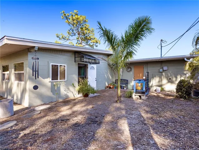 Backyard, garage to right, Den with access door to left