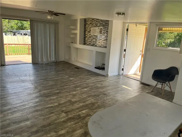 large living area with updated built in and laminate flooring. Access to the back deck.