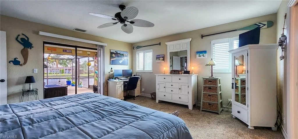 Bedroom featuring access to exterior, carpet, multiple windows, and ceiling fan