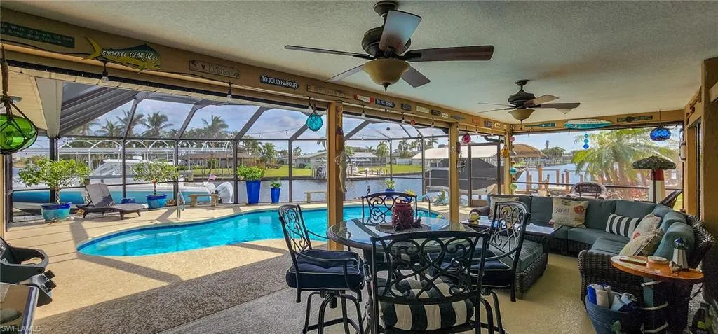 Pool with a lanai, outdoor lounge area, and a patio area