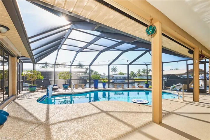 Outdoor pool with glass enclosure and a patio area