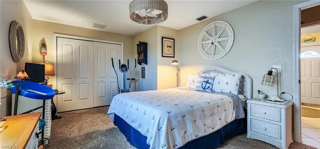 Bedroom featuring carpet flooring and a closet