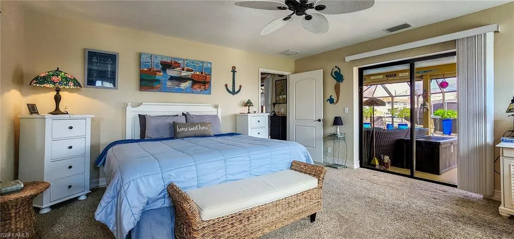 Carpeted bedroom featuring access to outside and ceiling fan