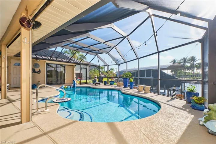 Outdoor pool with glass enclosure and a patio