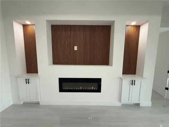 Entertainment area with built in electric fireplace.