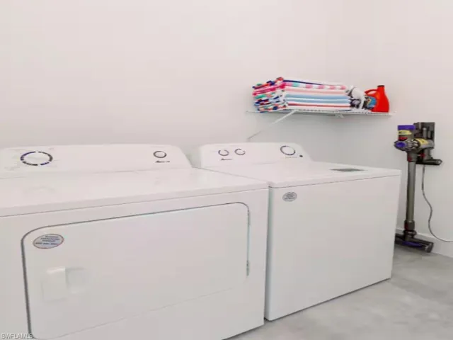Dedicated laundry area featuring a white washer and dryer set