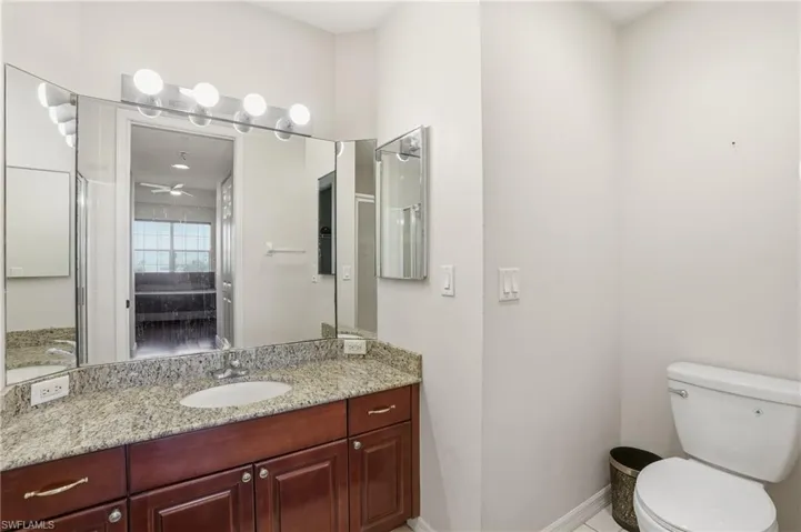 Ensuite bathroom with vanity and ceiling fan