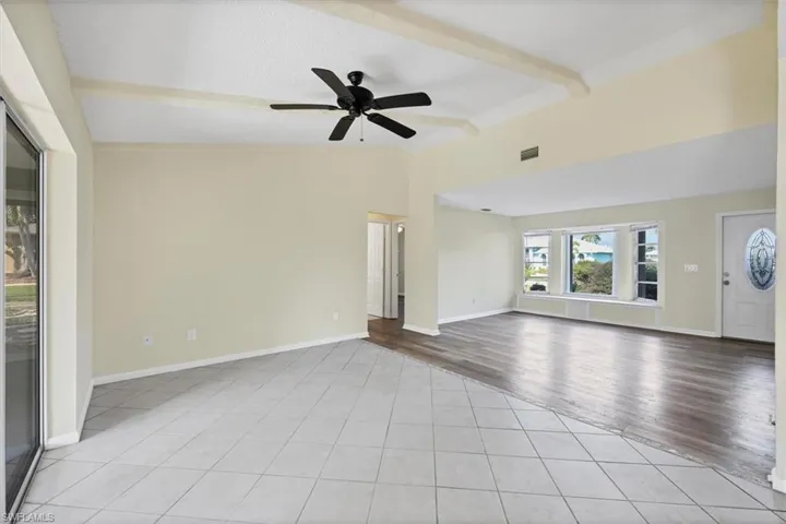 Unfurnished living room featuring light tile patterned flooring and a ceiling fan