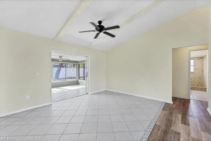 Unfurnished room featuring light tile patterned floors, a textured ceiling, a sunroom, and ceiling fan