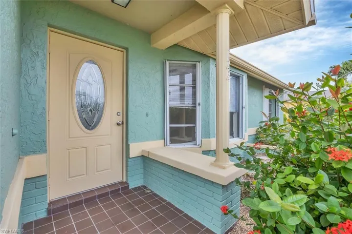Entrance to property featuring stucco siding