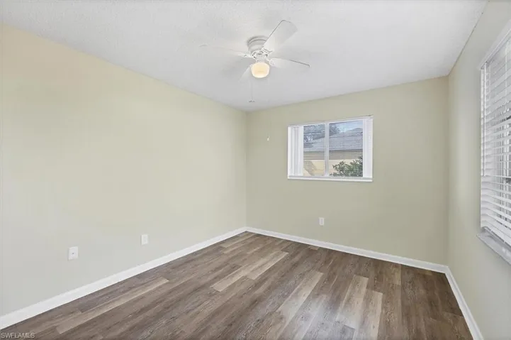 Unfurnished room featuring wood finished floors, a textured ceiling, and ceiling fan