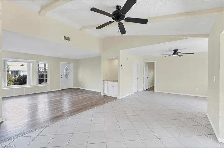 Unfurnished living room featuring light tile patterned floors and ceiling fan