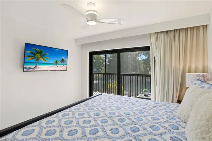 Bedroom featuring access to outside and a ceiling fan