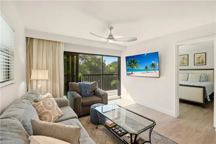Living area with ceiling fan and light wood-type flooring