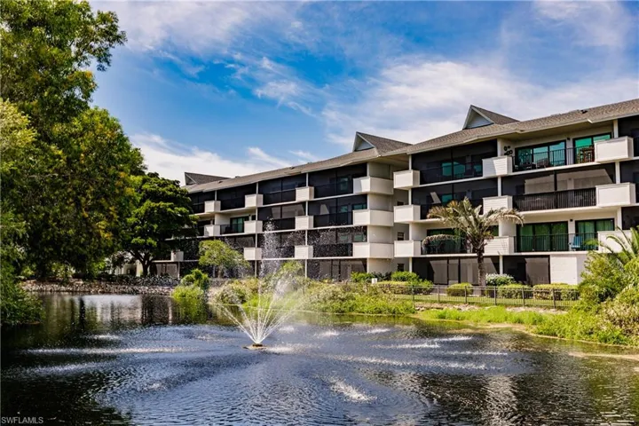 View of apartment building / complex featuring a water view