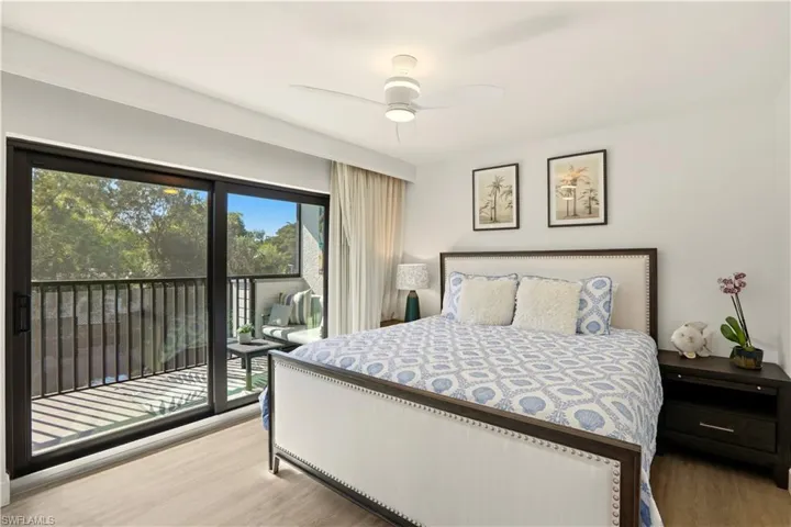 Bedroom featuring light wood-style floors, access to exterior, and a ceiling fan