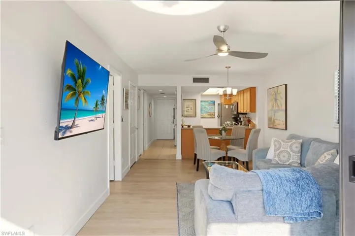 Living room featuring light wood-type flooring and ceiling fan