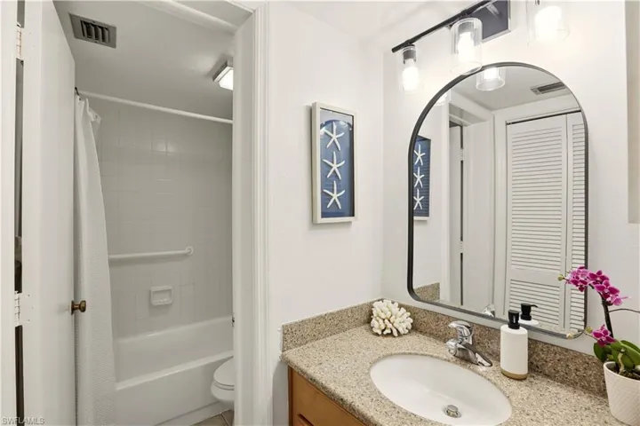 Bathroom featuring vanity and shower / tub combo