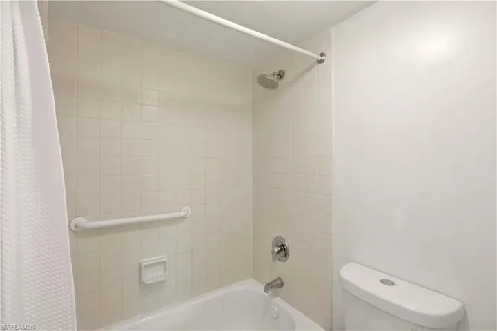 Full bathroom with shower / tub combo and toilet
