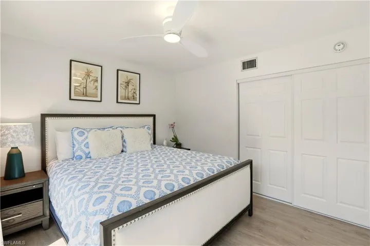 Bedroom with a closet, light wood finished floors, and ceiling fan
