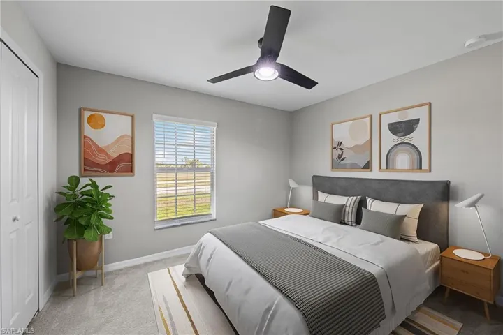 Bedroom with carpet floors, a closet, and ceiling fan