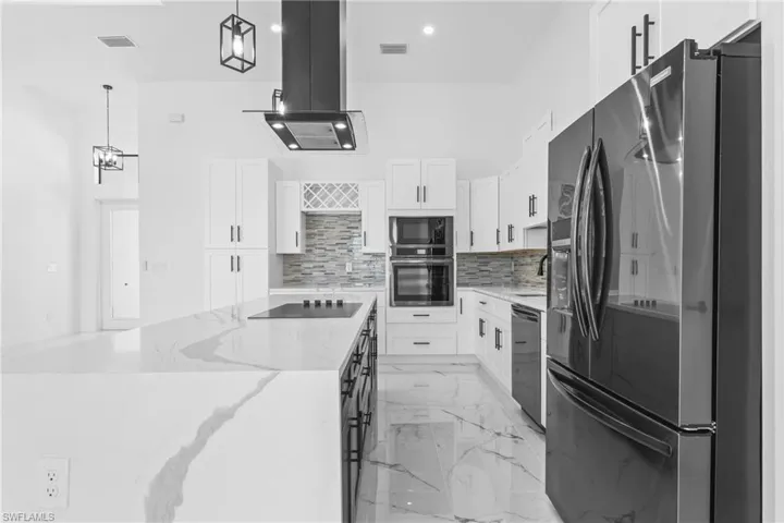 Cooktop on the Island, allows you to still entertain while cooking. Note- stunning Quartz Counters!