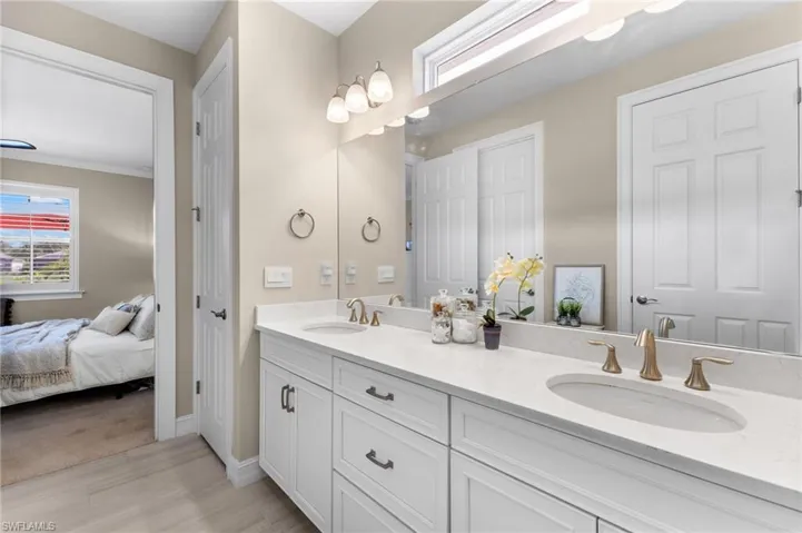 Bathroom with tile patterned floors and dual bowl vanity