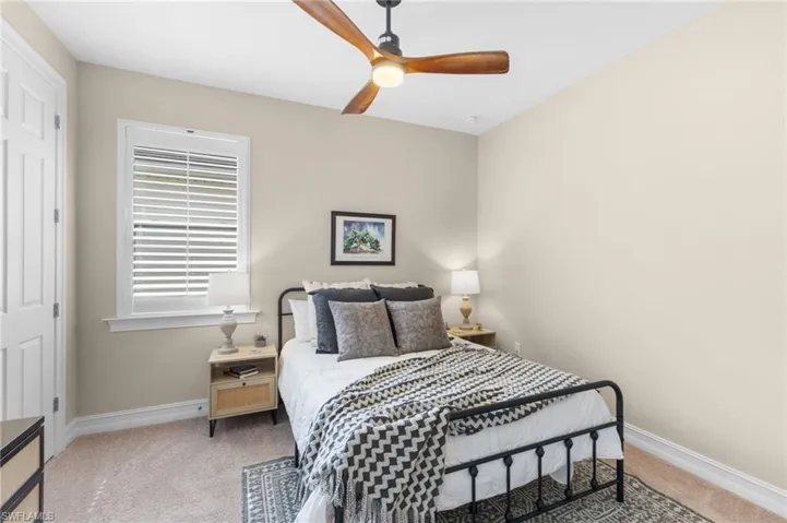 Carpeted bedroom with ceiling fan