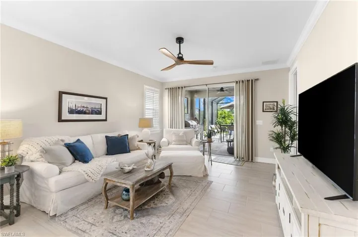 Living room with ceiling fan and crown molding