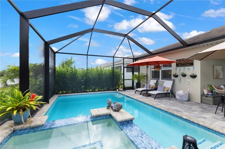 View of swimming pool featuring a lanai, a patio area, and outdoor lounge area
