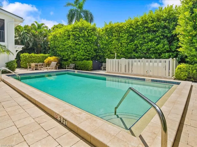 Community pool with a patio