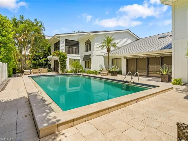Swimming pool with a patio area and a balcony