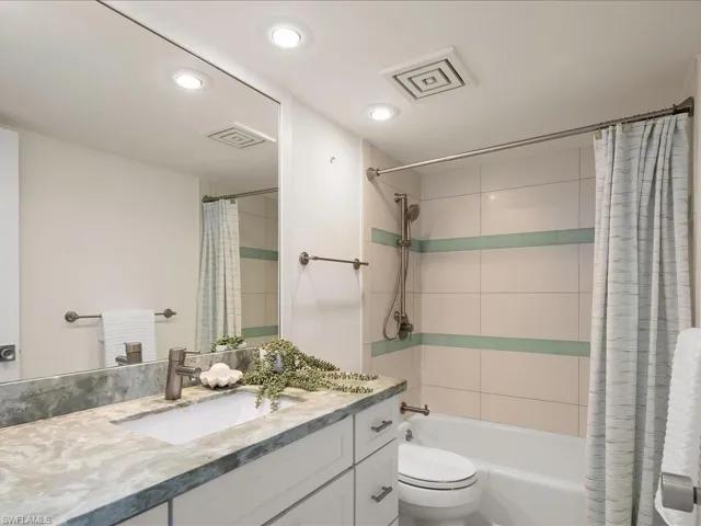 Full bathroom with shower / tub combo with curtain, vanity, and recessed lighting