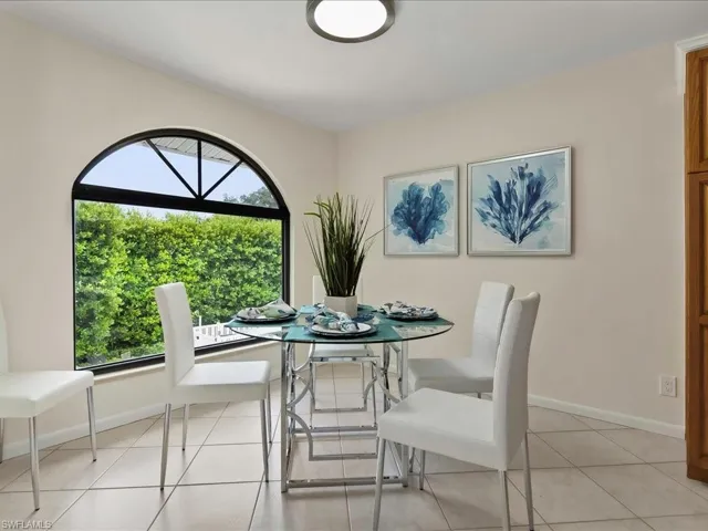 Dining space featuring light tile patterned flooring and baseboards