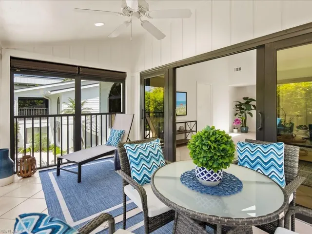 Sunroom featuring tile patterned flooring, vaulted ceiling, and recessed lighting