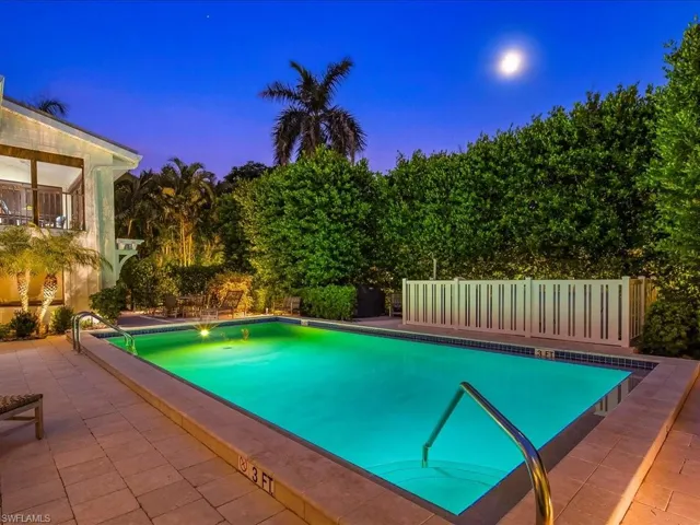 View of pool featuring a patio area and a balcony