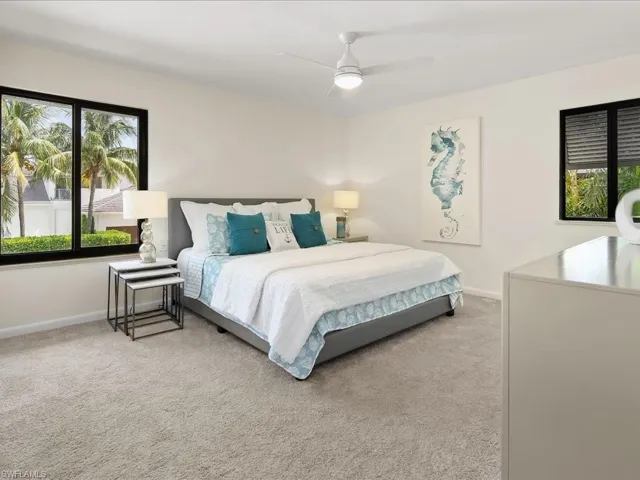 Bedroom featuring light colored carpet and a ceiling fan