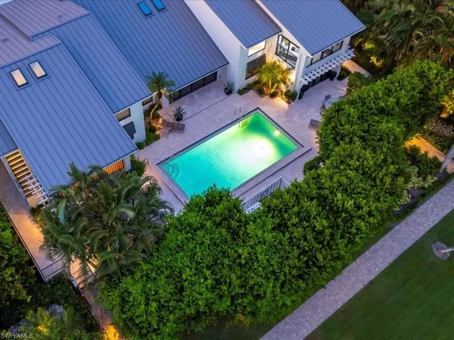 View of subject property featuring a pool area