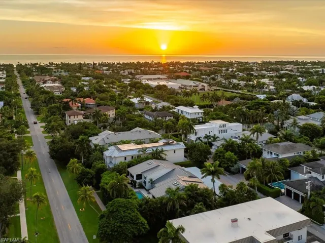 Aerial perspective of suburban area featuring a nearby body of water
