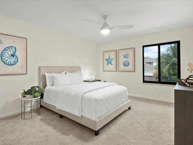 Carpeted bedroom with baseboards and a ceiling fan