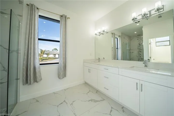 Bathroom featuring walk in shower and vanity