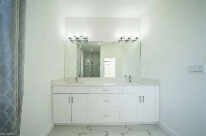 Bathroom with a shower with door and vanity