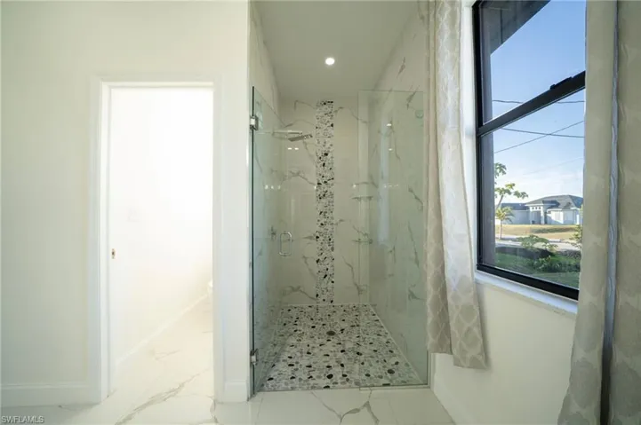 Bathroom with a shower with shower door