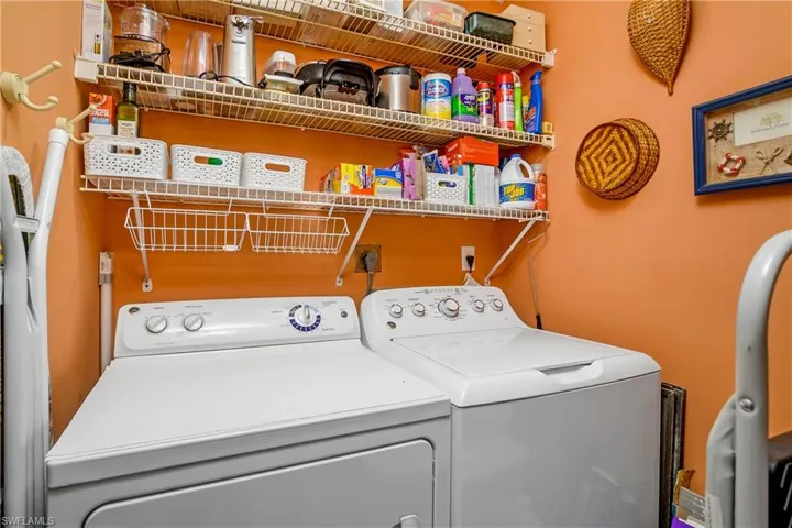 Washroom with washer and clothes dryer