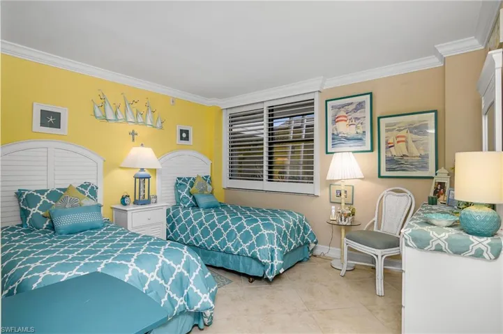 Tiled bedroom featuring crown molding