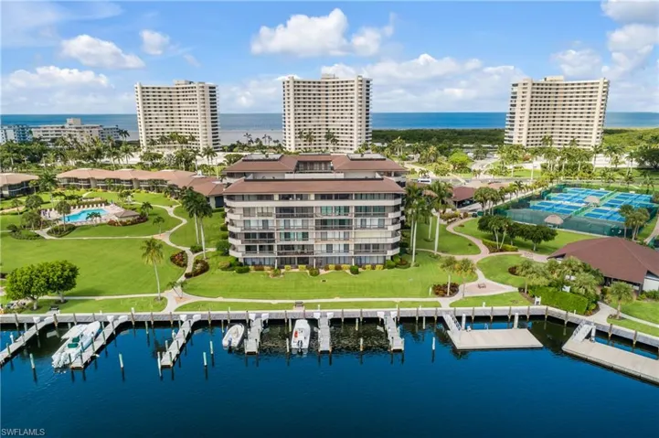 Birds eye view of property with a water view