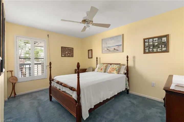 Carpeted bedroom featuring baseboards and ceiling fan